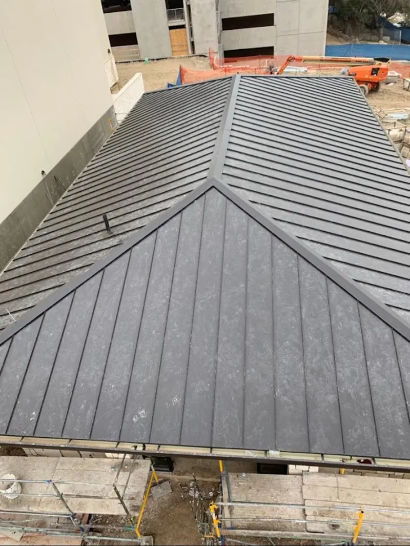 Commercial metal roof construction with crane equipment in Jan Phyl Village